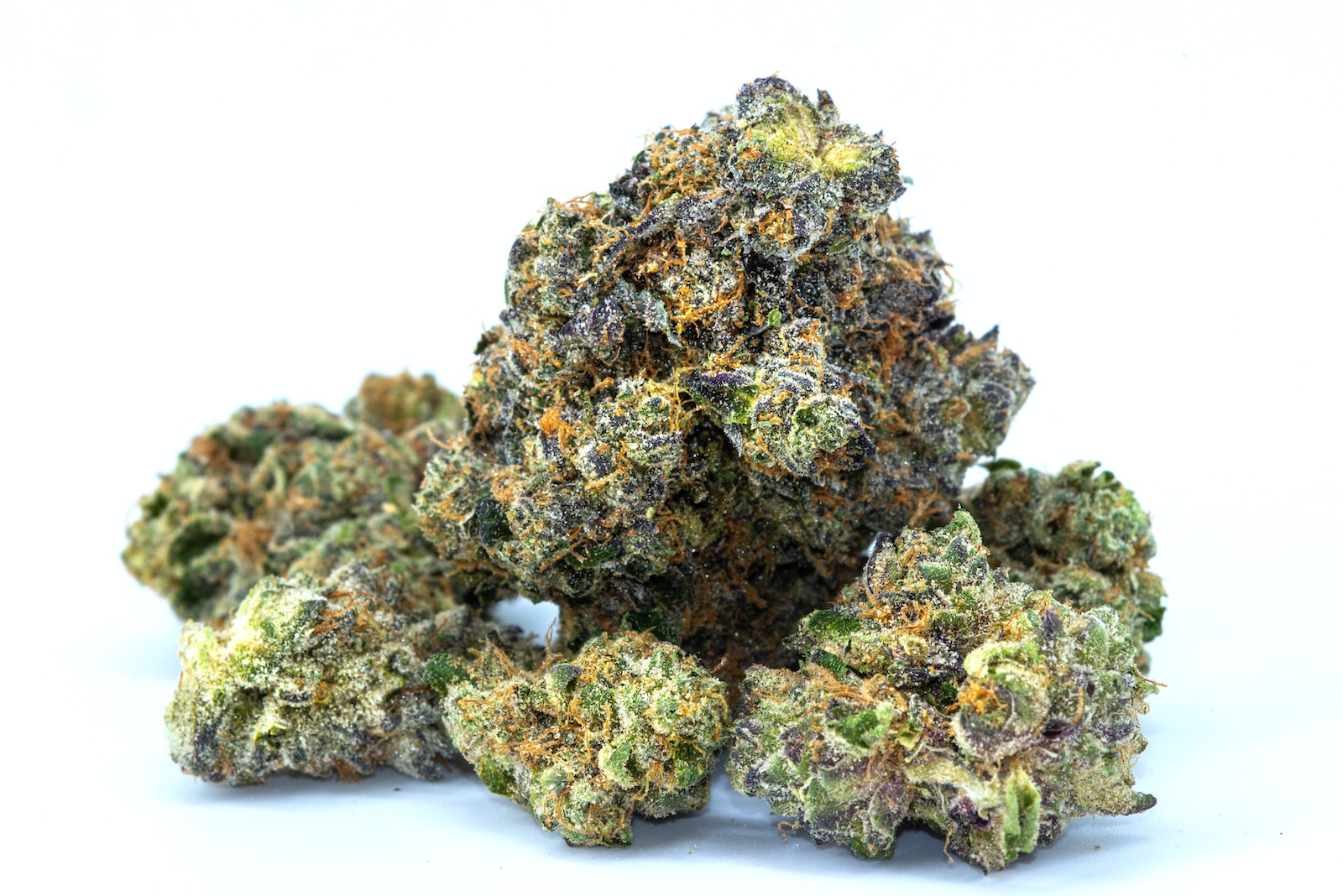 Close-up of high-quality cannabis buds showcasing vibrant green and purple hues, covered in trichomes, indicating potency and freshness. Ideal for cannabis enthusiasts and medicinal users seeking premium marijuana strains.